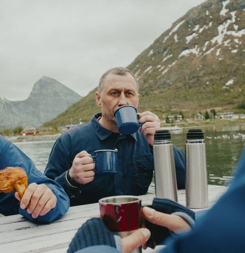 Man drinking  of two coffee cups